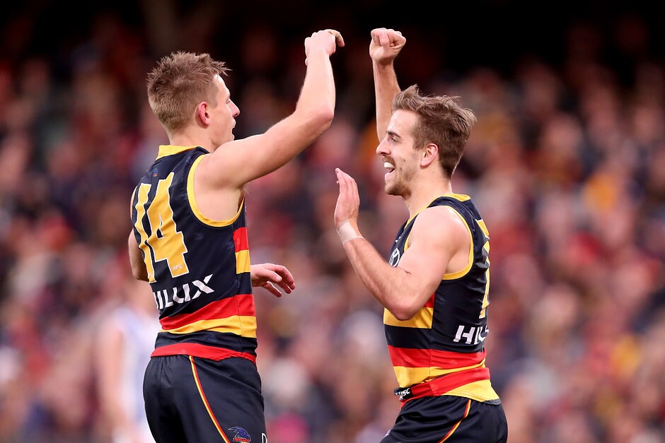 AFL 2018 Round 22 - Adelaide v North Melbourne ADELAIDE, AUSTRALIA - AUGUST 19: David Mackay and Jordan Gallucci of the Crows celebrate a goal during the 2018 AFL round 22 match between the Adelaide Crows and the North Melbourne Kangaroos at Adelaide Oval on August 19, 2018 in Adelaide, Australia. (Photo by James Elsby/AFL Media)